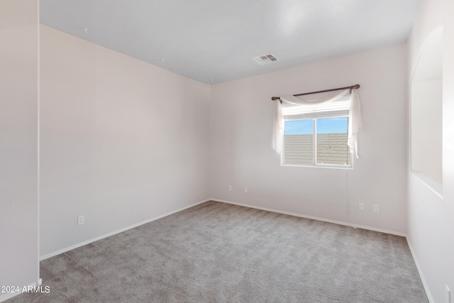 unfurnished room featuring light carpet