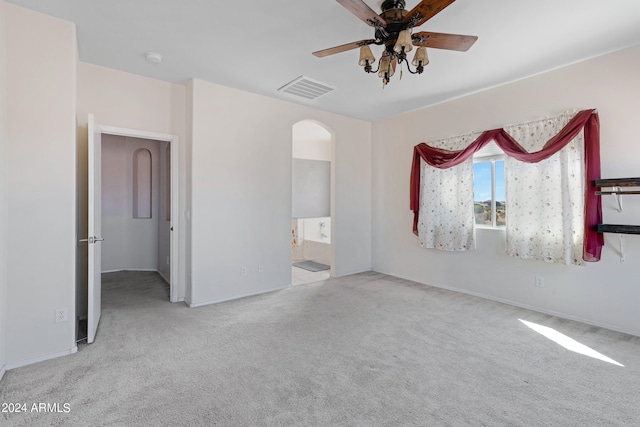 carpeted empty room featuring ceiling fan