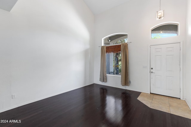 entrance foyer with high vaulted ceiling and wood-type flooring