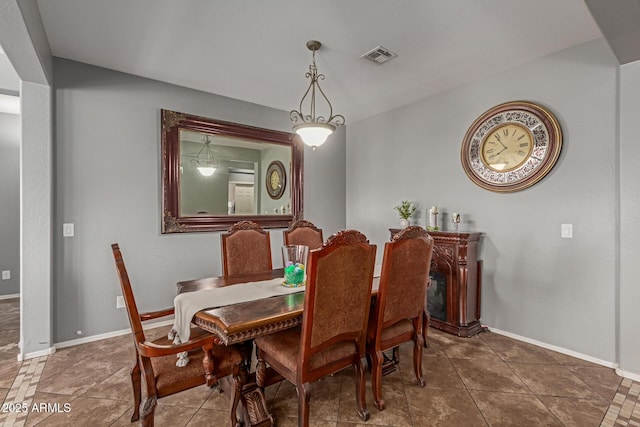 tiled dining room with visible vents and baseboards