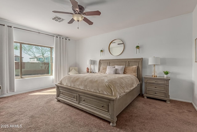 carpeted bedroom with visible vents, baseboards, and a ceiling fan