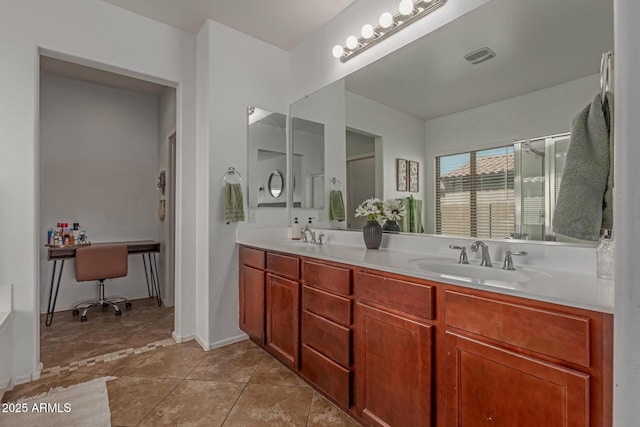 bathroom with a sink, visible vents, an enclosed shower, and double vanity