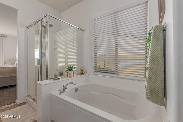 ensuite bathroom with a shower stall, a garden tub, and ensuite bathroom