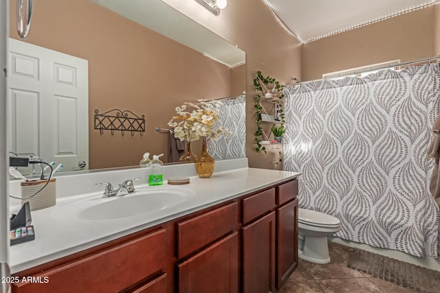 bathroom featuring a shower with shower curtain, toilet, vanity, and tile patterned flooring