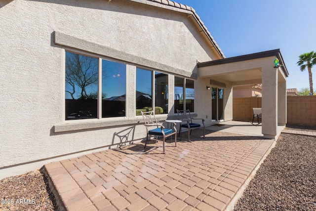 view of patio / terrace featuring fence