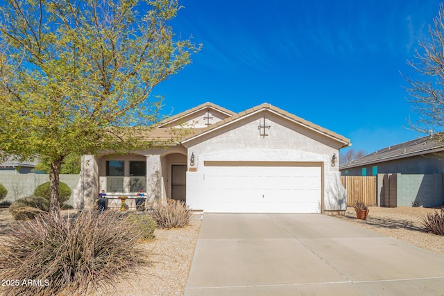 ranch-style house featuring stucco siding, fence, a garage, driveway, and a tiled roof