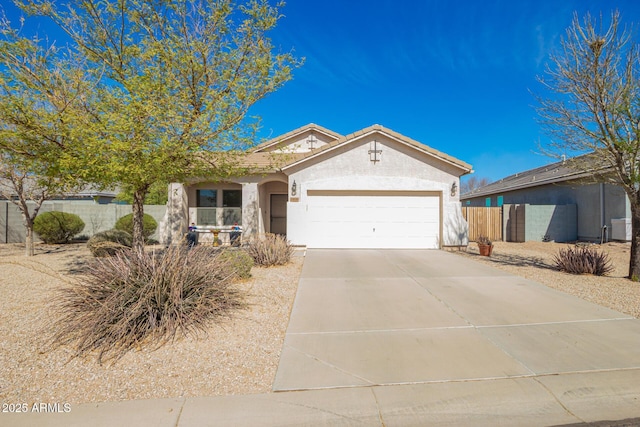 ranch-style home with a garage, concrete driveway, a tile roof, fence, and stucco siding