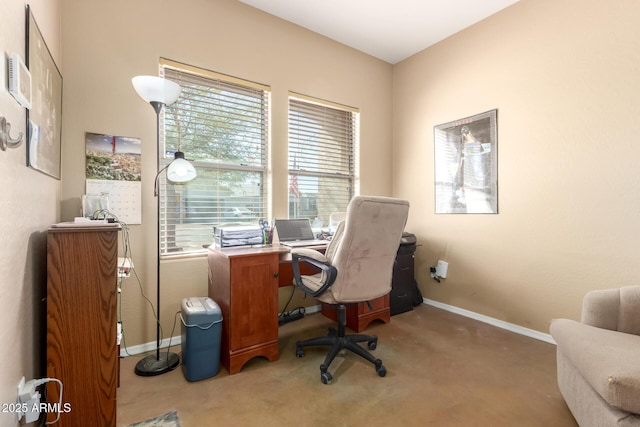 office space featuring baseboards and light colored carpet