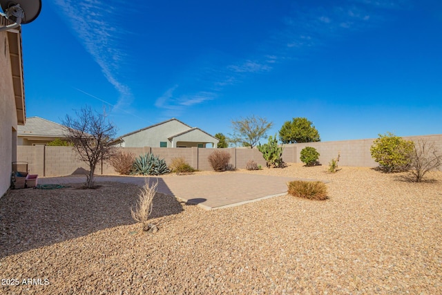 view of yard featuring a patio area and a fenced backyard