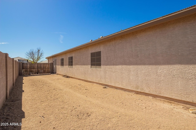 view of property exterior with a fenced backyard and stucco siding