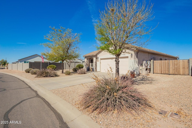 ranch-style home featuring concrete driveway, fence, an attached garage, and stucco siding