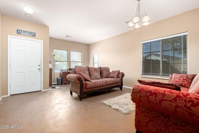 living room with visible vents, baseboards, and an inviting chandelier