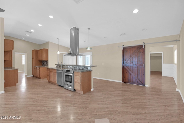 4112 N 4th Ave, Phoenix, AZ 85013 - kitchen featuring island exhaust hood, appliances with stainless steel finishes, open floor plan, light wood-style flooring, and tasteful backsplash