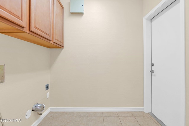4112 N 4th Ave, Phoenix, AZ 85013 - laundry area featuring electric dryer hookup, baseboards, cabinet space, and light tile patterned floors