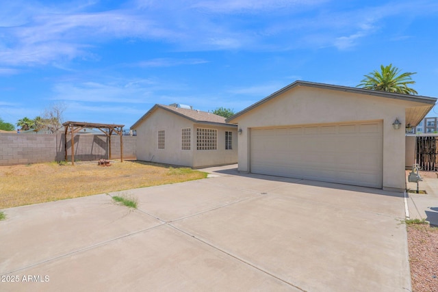 4112 N 4th Ave, Phoenix, AZ 85013 - ranch-style home featuring stucco siding, a garage, driveway, and a pergola