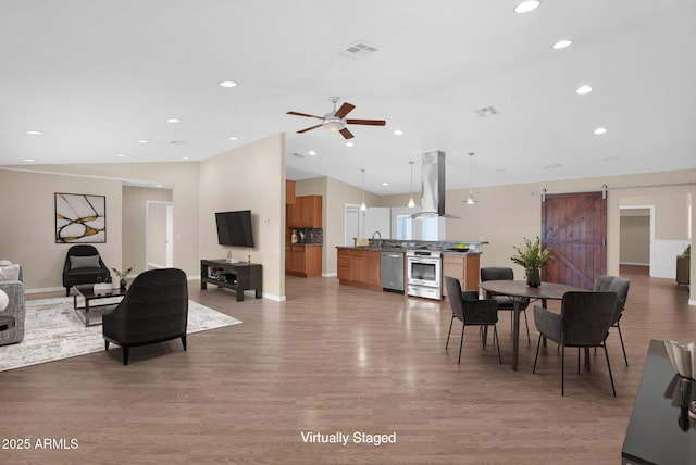 4112 N 4th Ave, Phoenix, AZ 85013 - living area featuring a barn door, vaulted ceiling, light wood-style flooring, ceiling fan, and recessed lighting