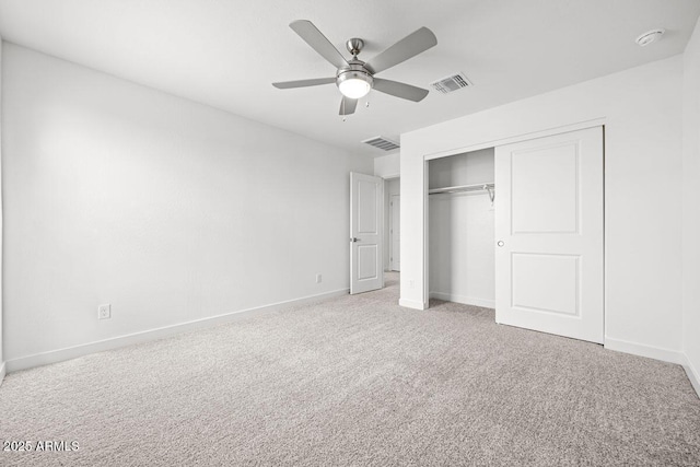 unfurnished bedroom featuring carpet, a closet, visible vents, and baseboards