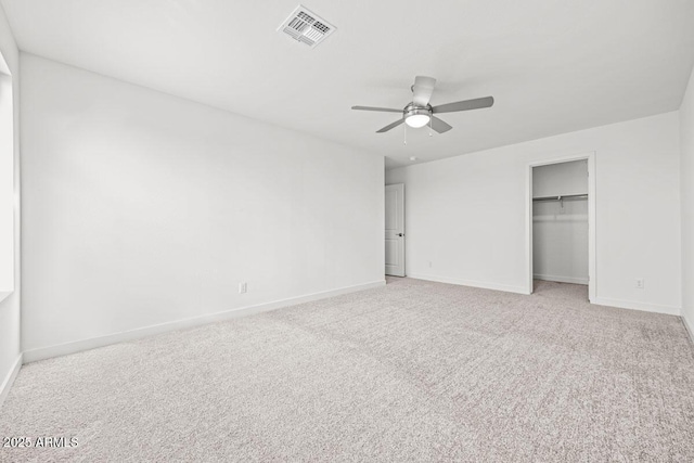 unfurnished bedroom featuring light carpet, baseboards, visible vents, a ceiling fan, and a closet