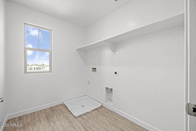 clothes washing area with laundry area, light wood-style floors, washer hookup, and hookup for a gas dryer