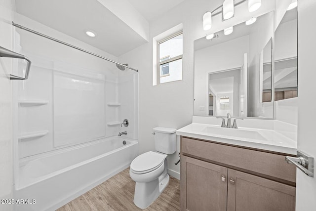 bathroom with bathing tub / shower combination, a wealth of natural light, toilet, vanity, and wood finished floors