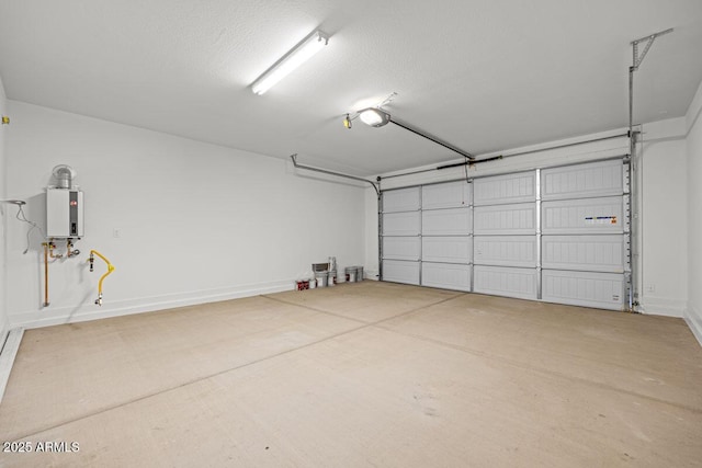 garage featuring baseboards, tankless water heater, and a garage door opener