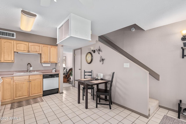 kitchen with light brown cabinetry, dishwasher, light tile patterned floors, and sink