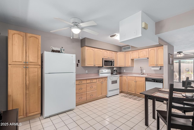 kitchen featuring light brown cabinets, white appliances, and sink