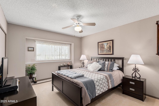 carpeted bedroom featuring ceiling fan and a textured ceiling