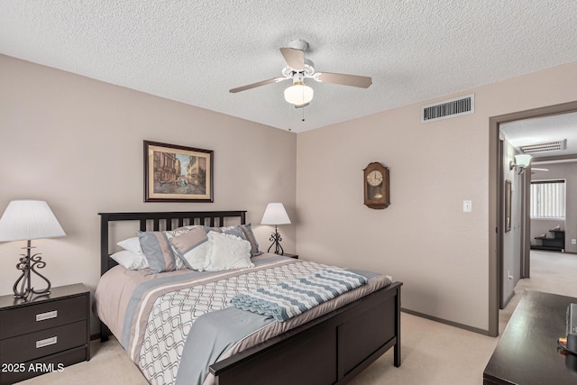 carpeted bedroom with ceiling fan and a textured ceiling