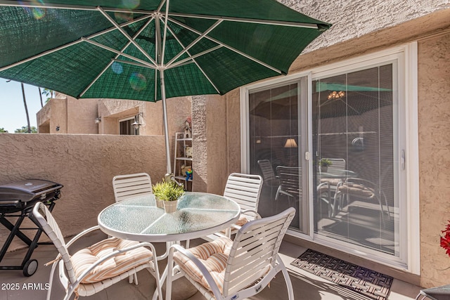 view of patio featuring a balcony