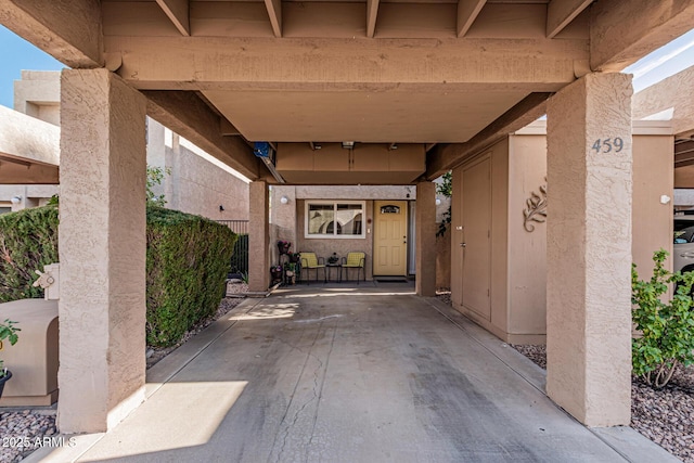 doorway to property featuring a carport