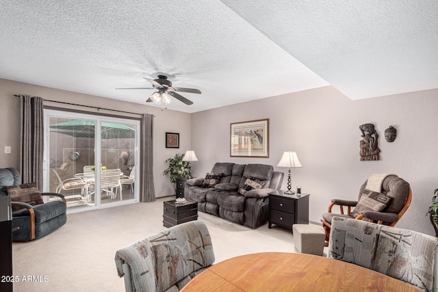 carpeted living room with ceiling fan and a textured ceiling