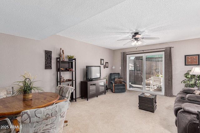 carpeted living room with a textured ceiling and ceiling fan