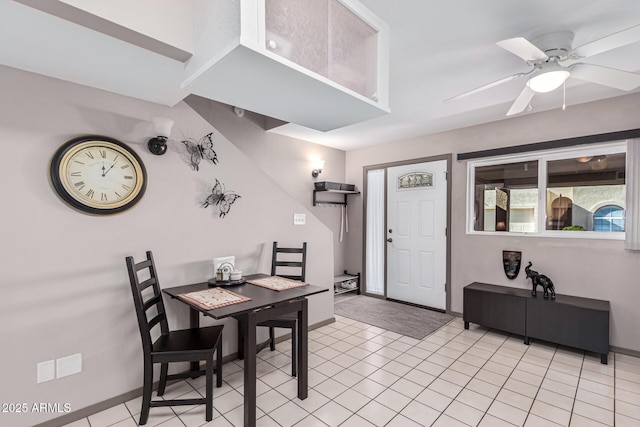 tiled dining space with ceiling fan