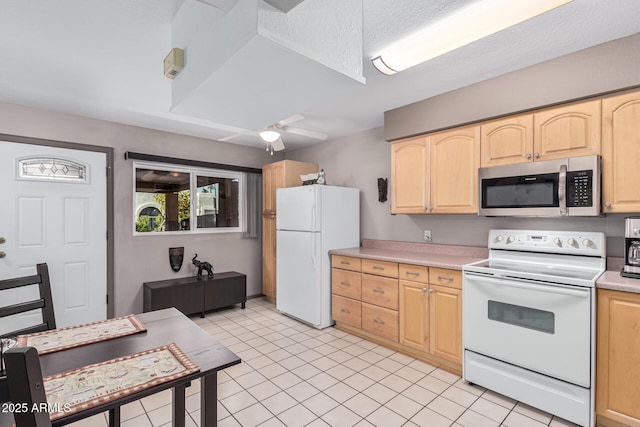 kitchen featuring ceiling fan, light brown cabinetry, and white appliances