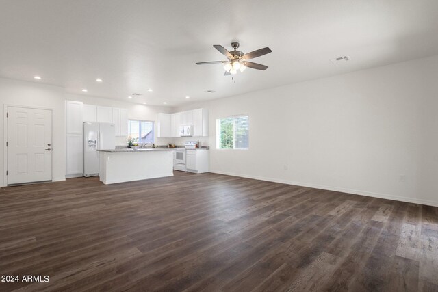 unfurnished living room with ceiling fan and dark hardwood / wood-style floors