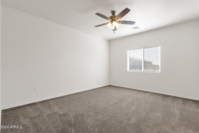 empty room featuring carpet flooring and ceiling fan