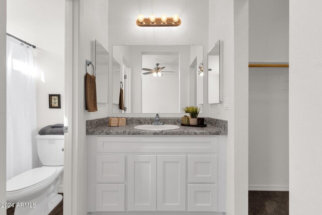 bathroom with vanity, toilet, and ceiling fan