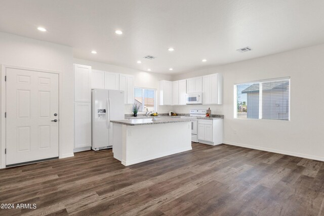 kitchen featuring dark wood-type flooring, ceiling fan, and white appliances