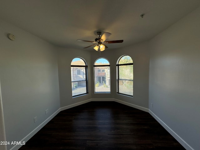 spare room featuring ceiling fan and dark hardwood / wood-style floors