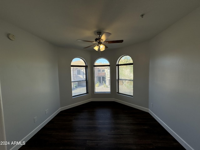14000 N 94th St Unit 1037, Scottsdale, AZ 85260 - unfurnished room with baseboards, a ceiling fan, and dark wood-style flooring