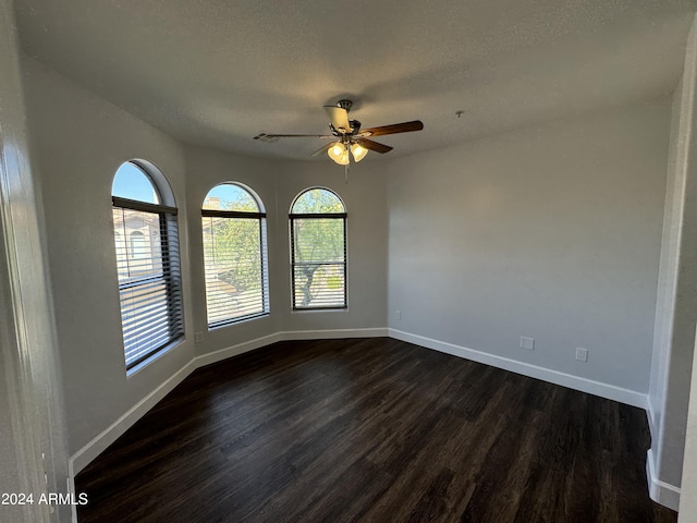 14000 N 94th St Unit 1037, Scottsdale, AZ 85260 - unfurnished room with dark wood-style floors, baseboards, a ceiling fan, and a textured ceiling