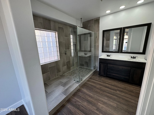 bathroom featuring vanity, a shower with door, and hardwood / wood-style floors