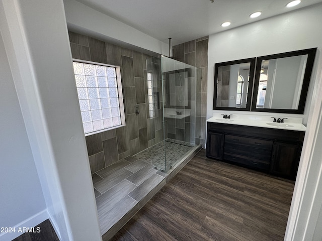 14000 N 94th St Unit 1037, Scottsdale, AZ 85260 - bathroom with recessed lighting, wood finished floors, a walk in shower, double vanity, and a sink