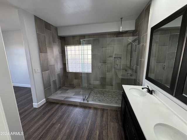 14000 N 94th St Unit 1037, Scottsdale, AZ 85260 - full bath featuring a stall shower, wood finished floors, double vanity, and a sink