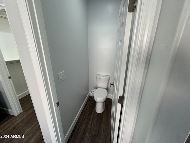 bathroom with wood-type flooring and toilet