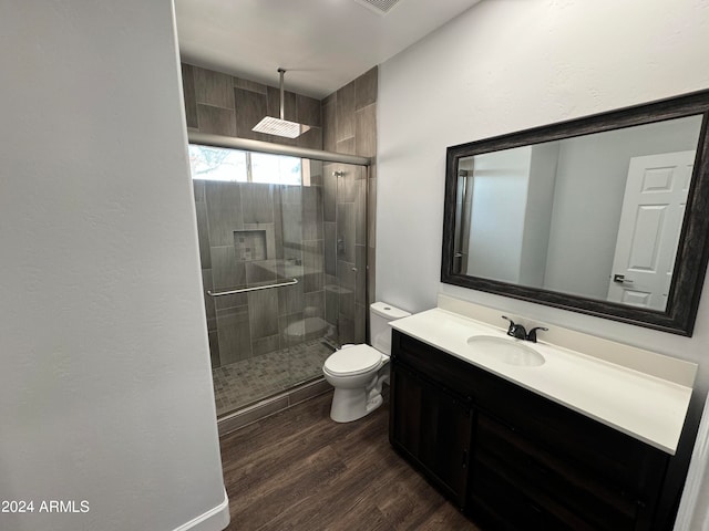 bathroom featuring vanity, toilet, an enclosed shower, and hardwood / wood-style flooring