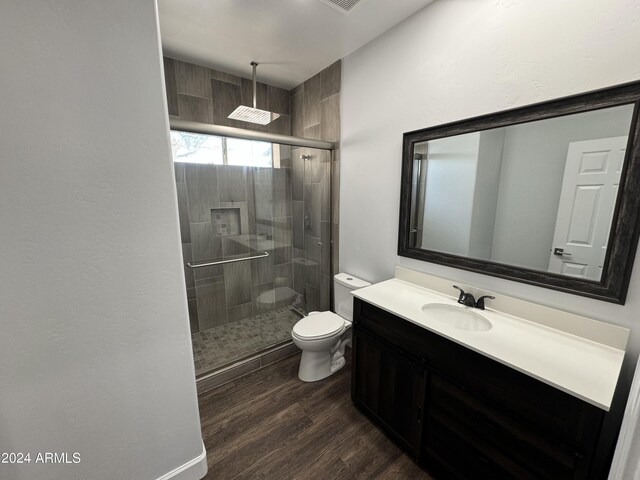 14000 N 94th St Unit 1037, Scottsdale, AZ 85260 - bathroom featuring toilet, a shower stall, wood finished floors, and vanity
