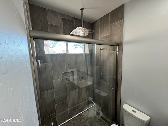 bathroom featuring an enclosed shower and toilet