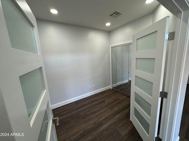 hall with dark hardwood / wood-style floors